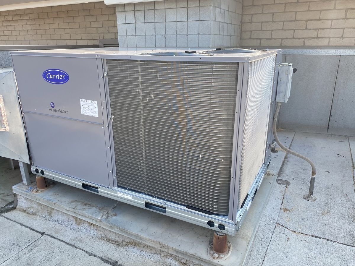 New Carrier rooftop package unit installed on a commercial building