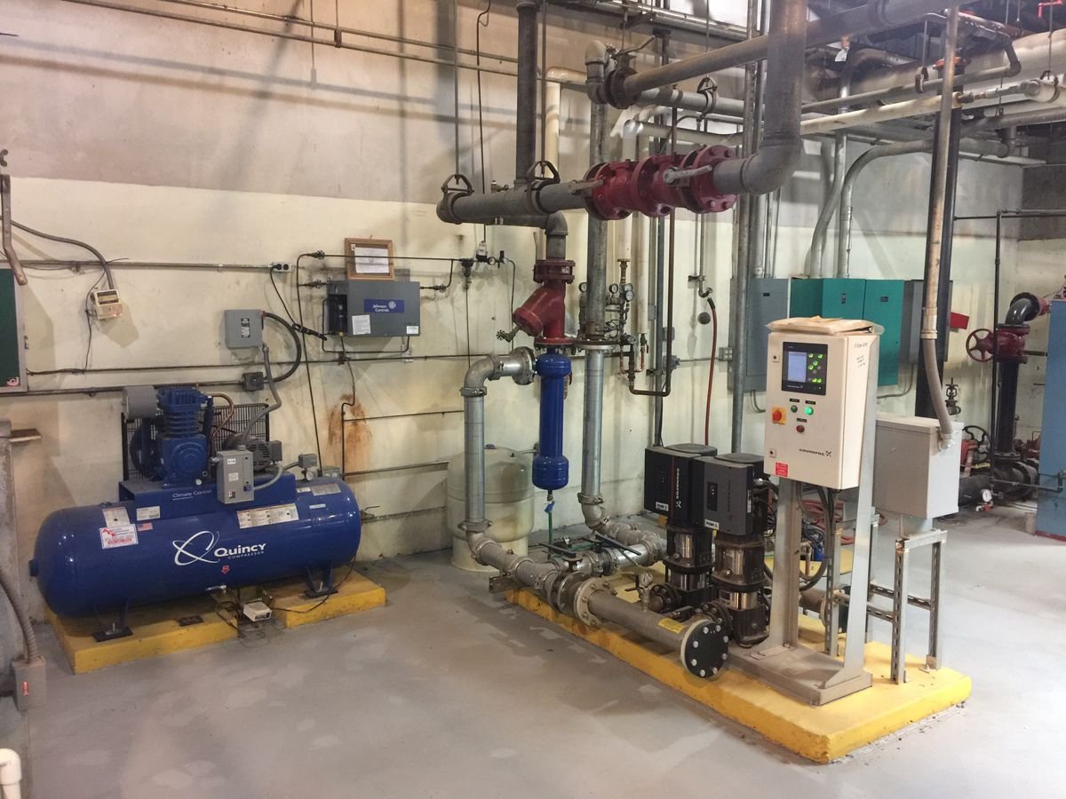Boiler-room pump skid with VFD controls and compressed-air system