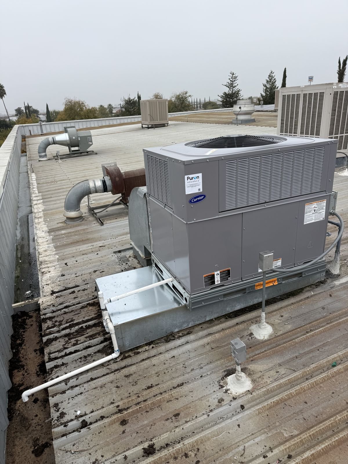 New Carrier package unit installed on a commercial metal roof