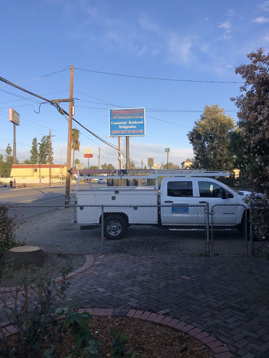 JP Air Conditioning & Heating service truck on the road in Fresno